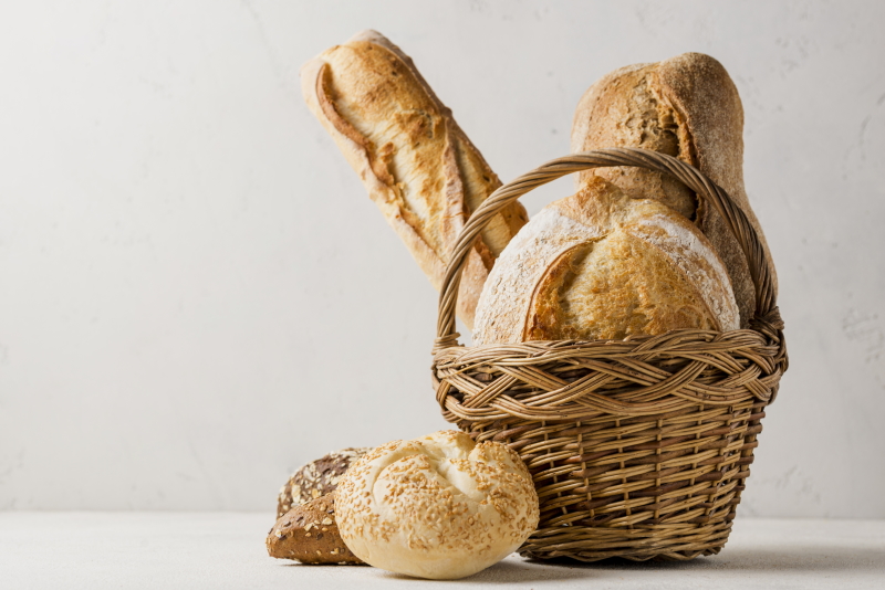 basket with various white whole grain bread